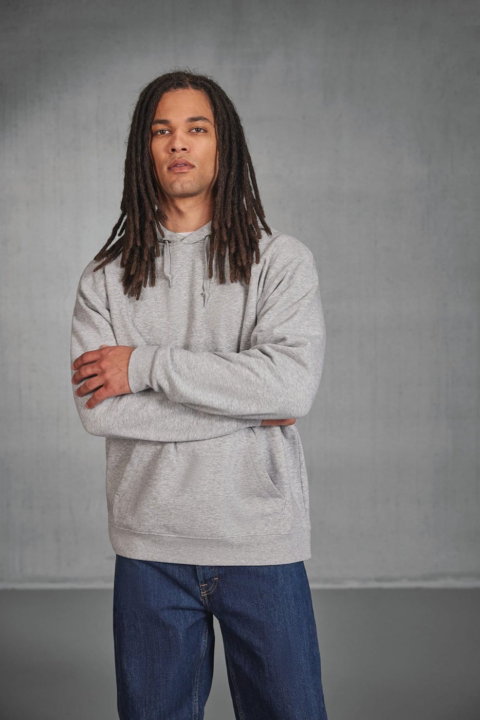 Man met lange dreadlocks in een grijze hoodie