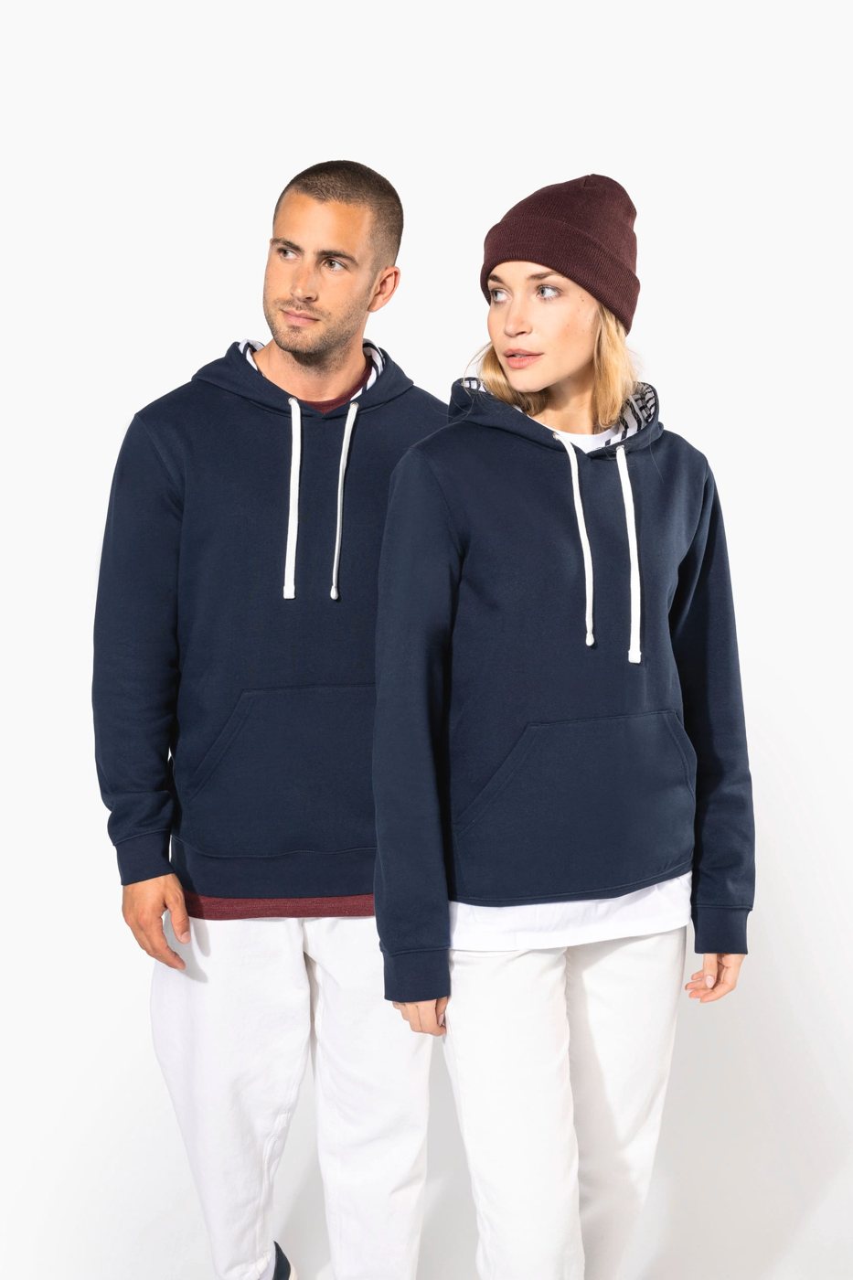 Man and woman wearing a burgundy beanie in a dark blue hoodie