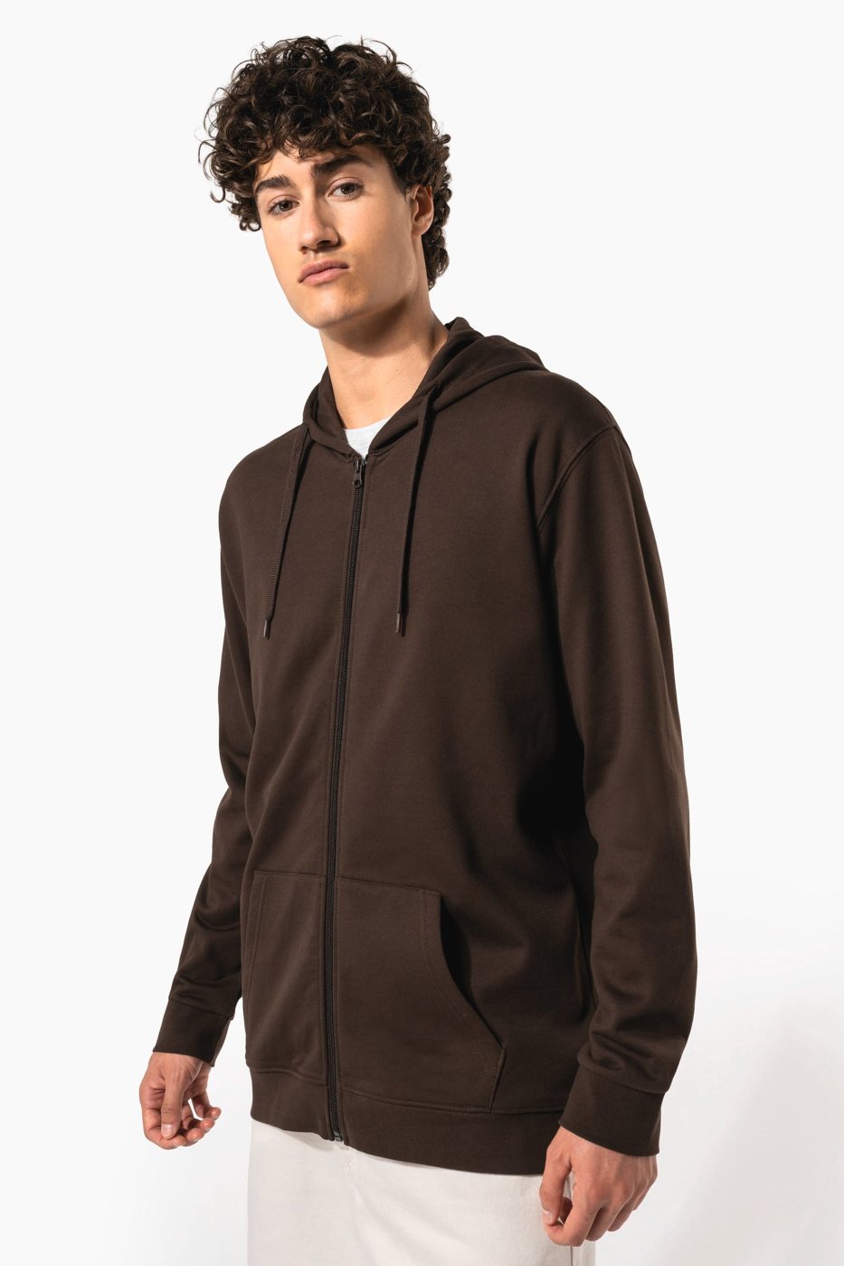 Curly-haired man in a chocolate brown zip-up hoodie