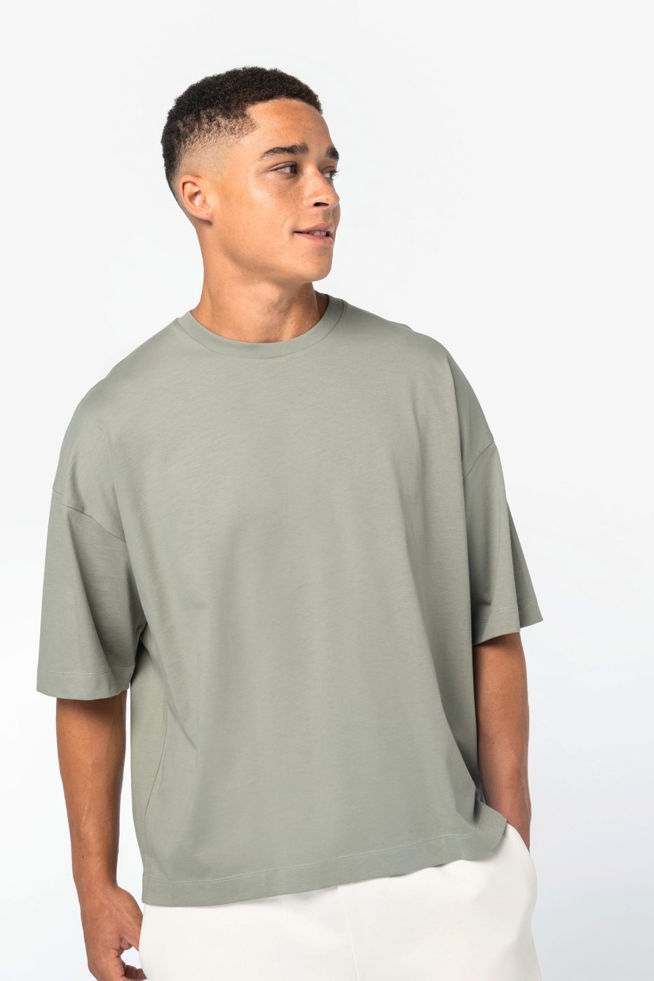 Man in a sage green boxy T-shirt