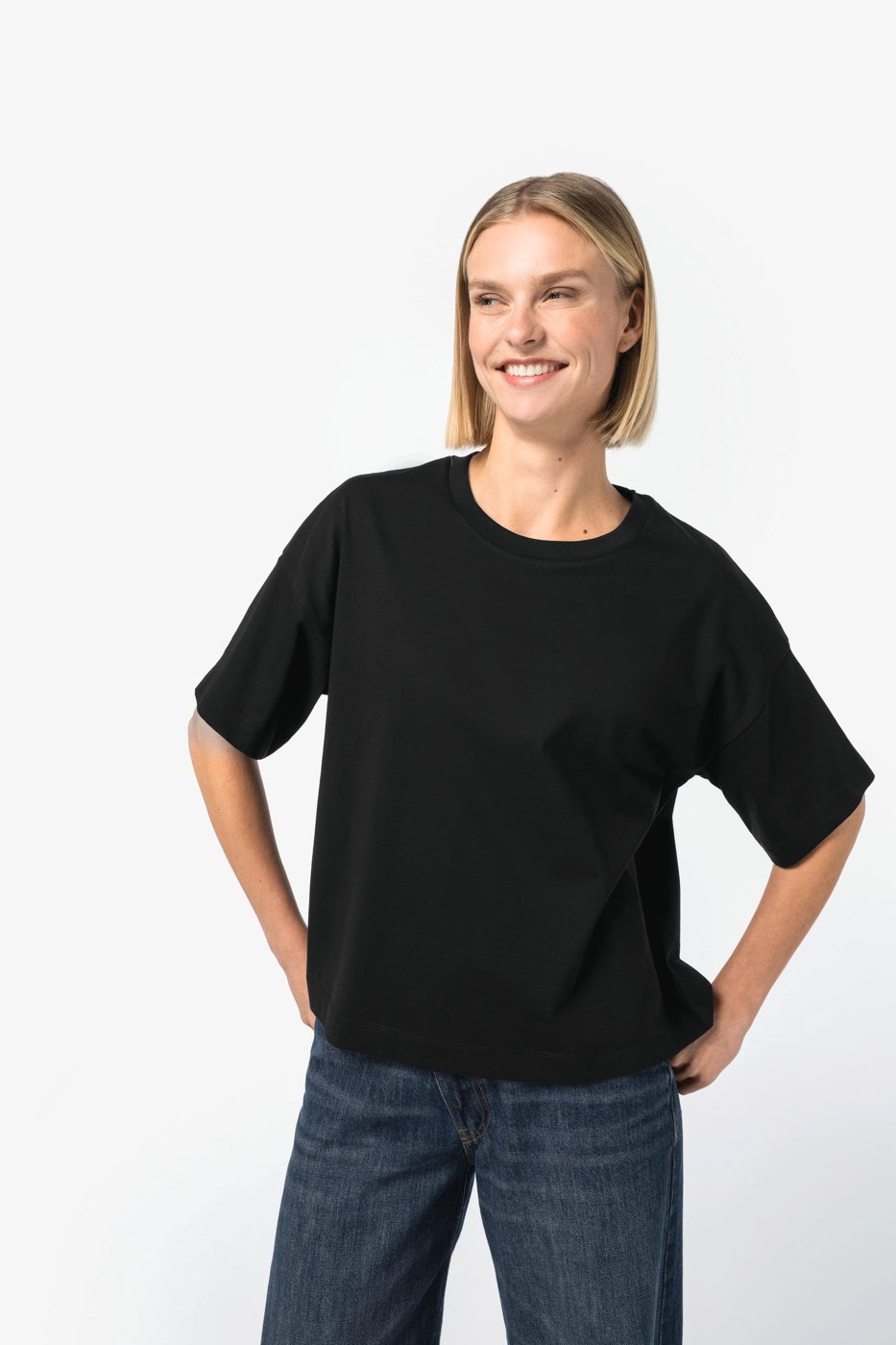 Smiling woman in a black boxy T-shirt