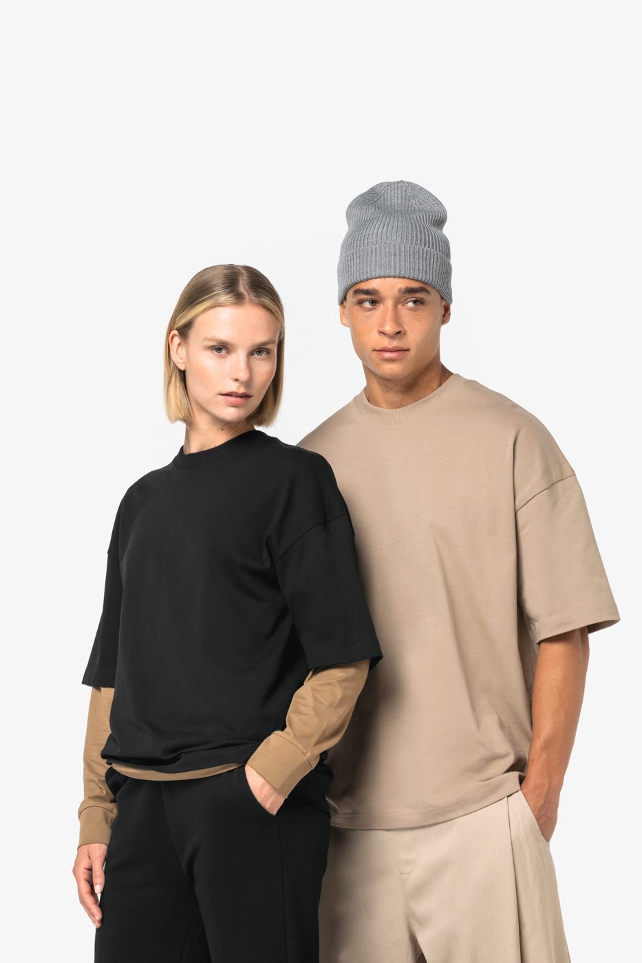 Woman and man in an oversized T-shirt in black and sand