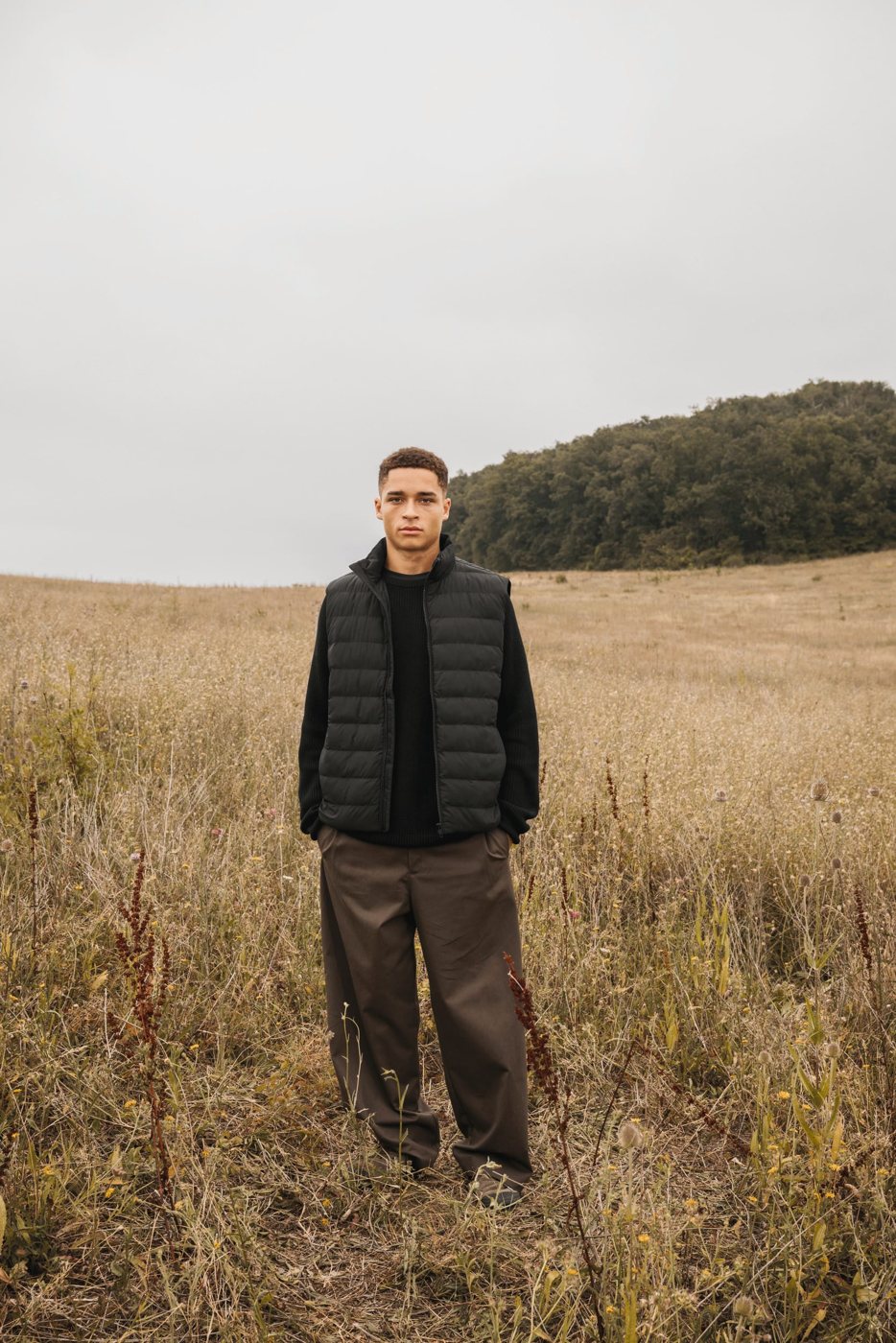 Man in a black quilted bodywarmer in a field