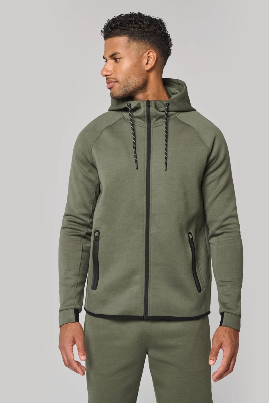 Man in a khaki performance hooded jacket with zip