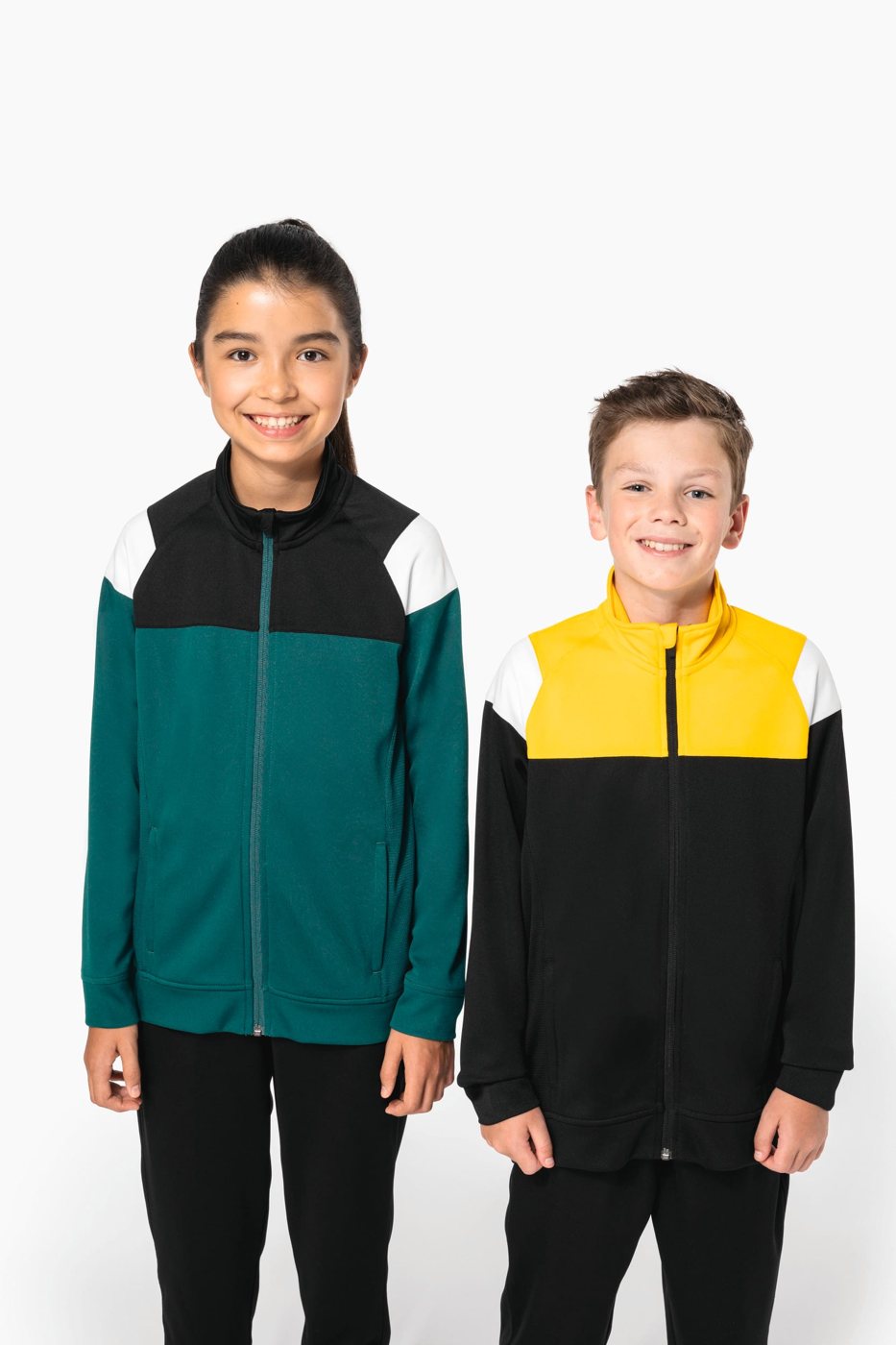 Smiling girl in a green and boy in a yellow and black track jacket