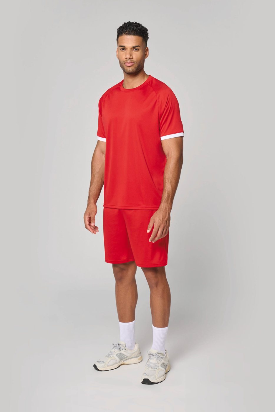 Man in a red sports shirt with matching red shorts