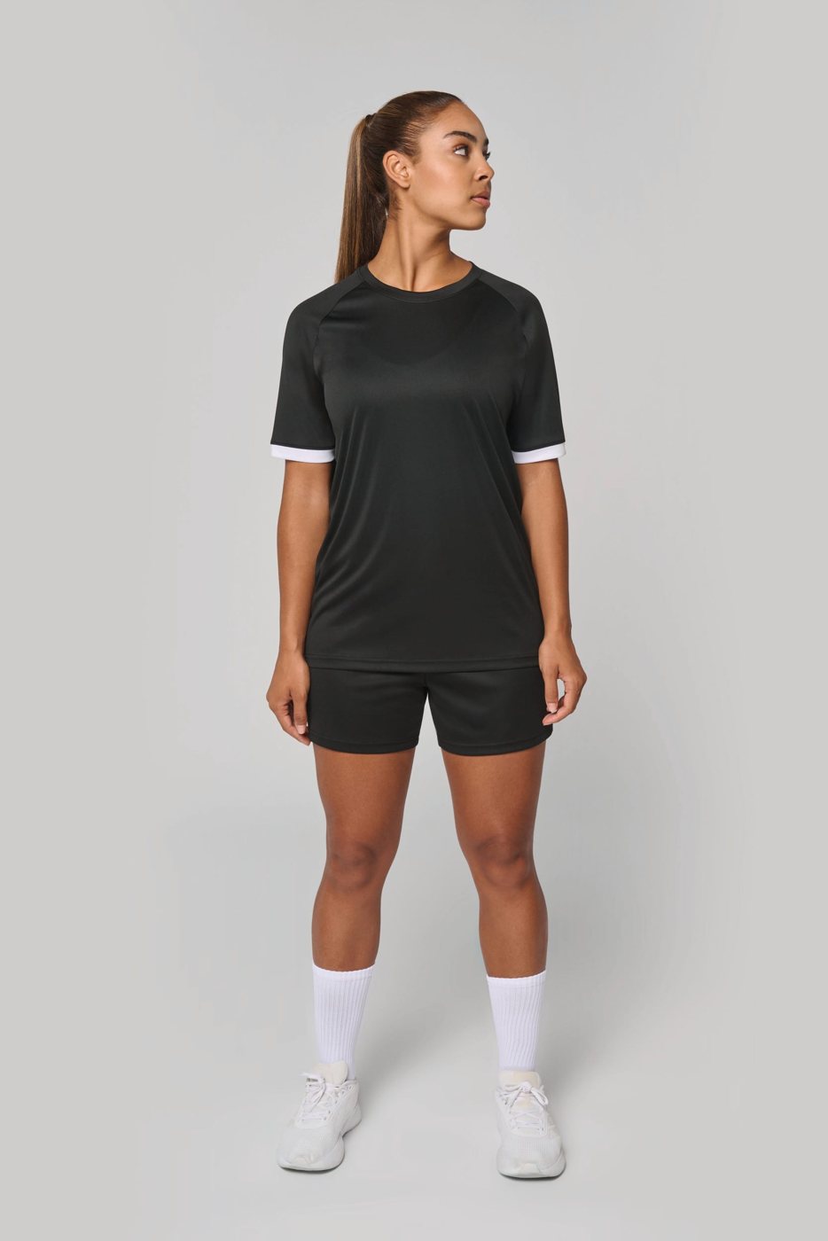 Woman in a black sports shirt and black shorts