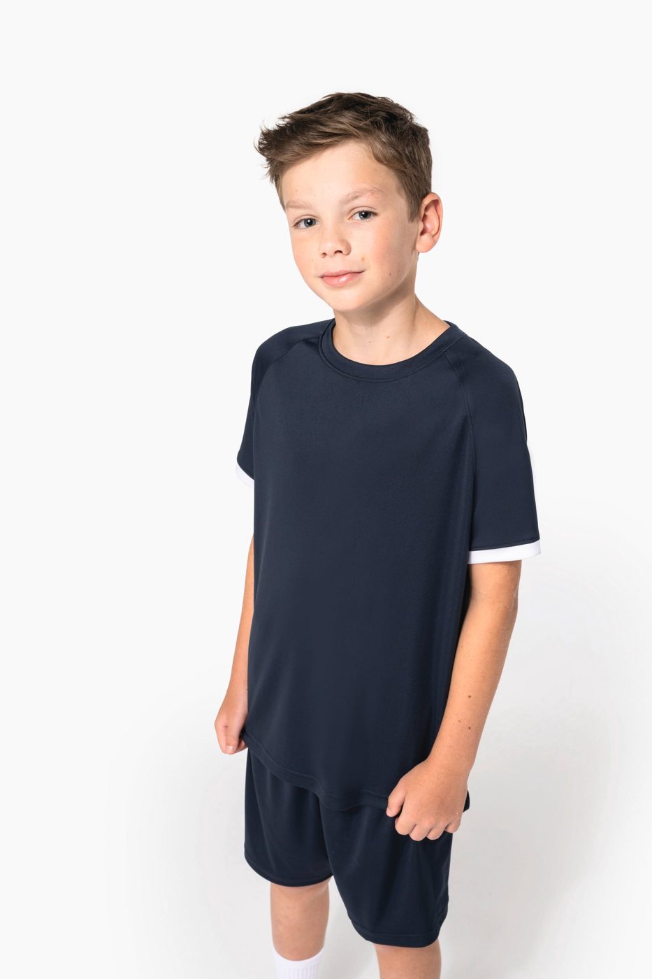 Boy in a navy sports shirt and shorts