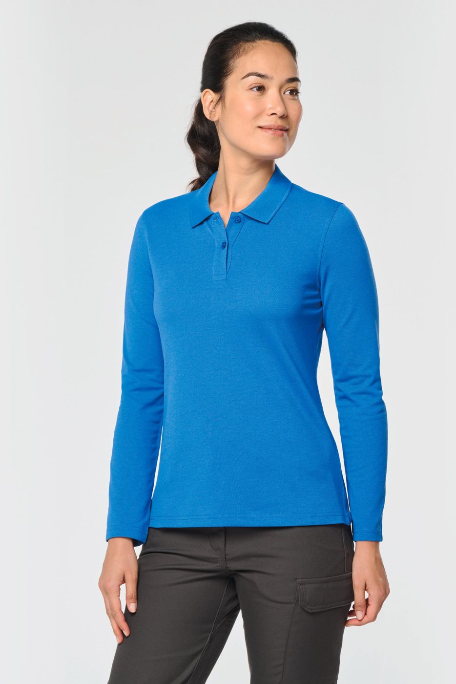 Vrouw in een koningsblauwe polo met lange mouwen