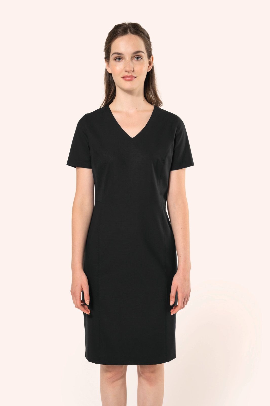 Woman in a black straight dress with a V-neck