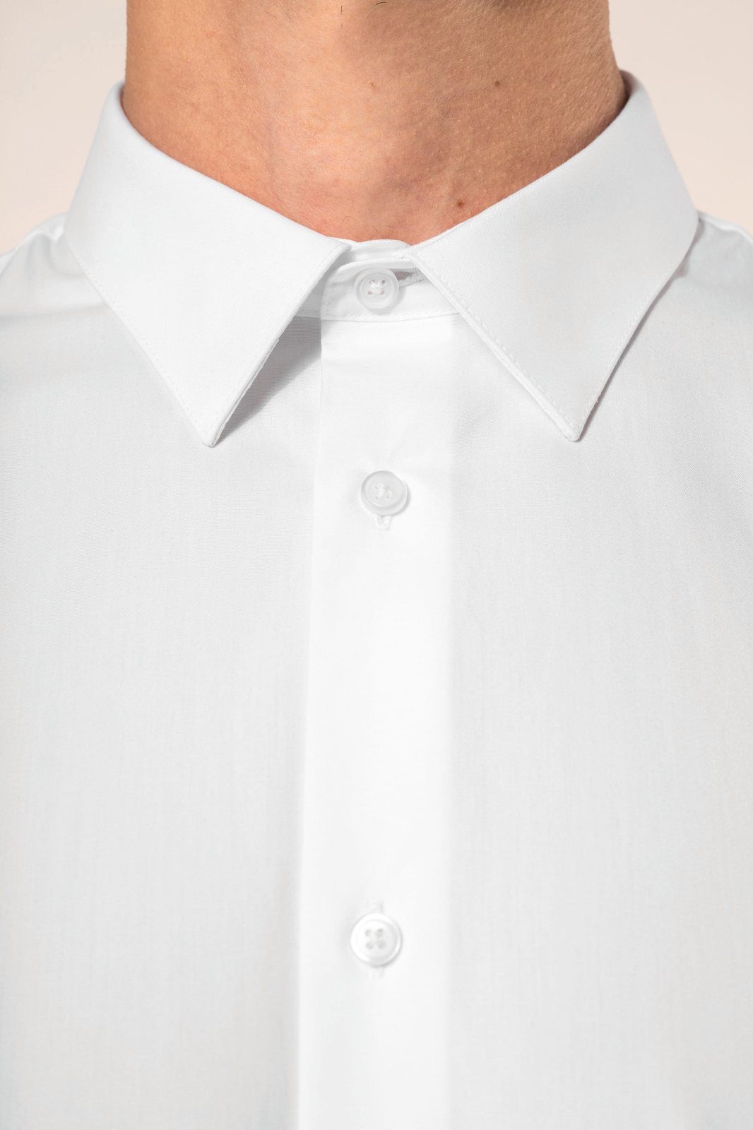 Close-up of the collar and button fastening of a white shirt