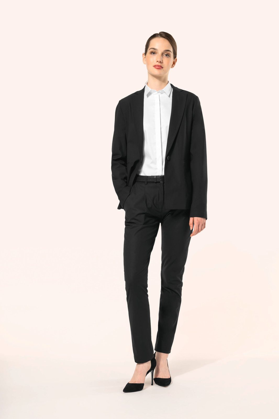 Woman in a black blazer and black trousers on heels