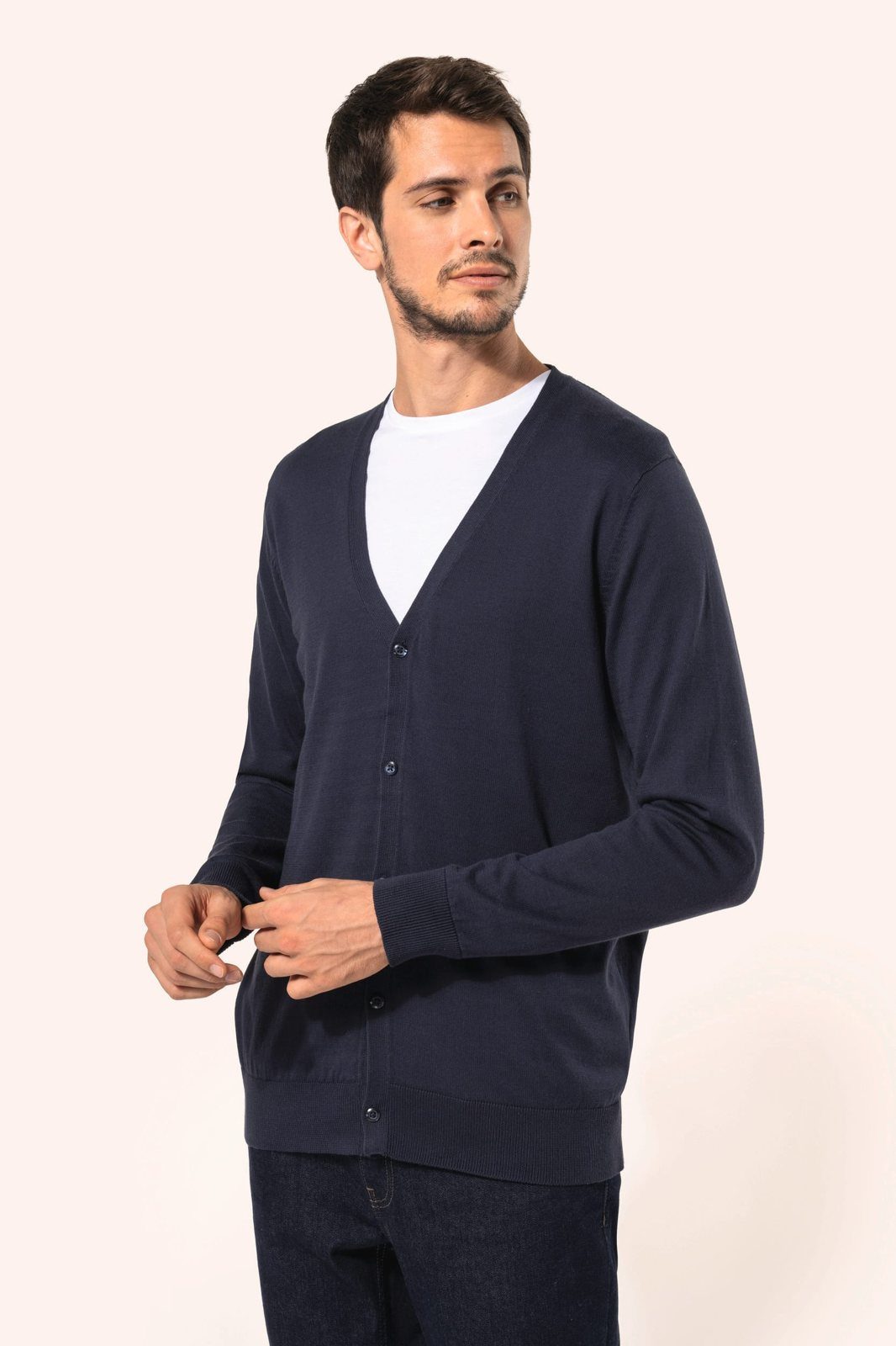 Man in a dark blue buttoned waistcoat over a white T-shirt