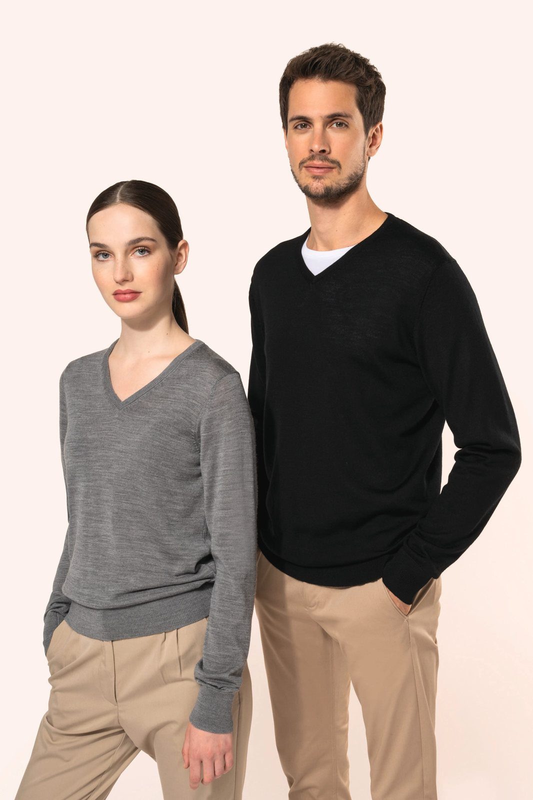 Woman in a grey and man in a black merino V-neck jumper