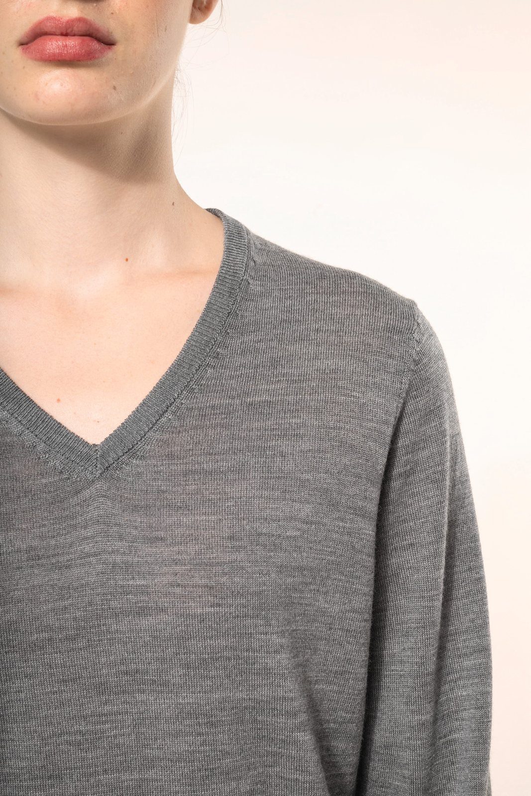 Close-up of the V-neck of a grey merino jumper